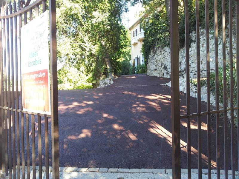 Image Aménagement d'une entrée avec une allée carrossable en pente en bitume rouge par Daniel Moquet Aix-en-Pro